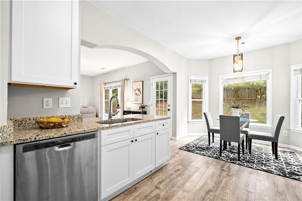 3720 Brookefall Landing Suwanee, GA 30024 - Photo 19 of 41 a view of a kitchen area with furniture and wooden floor