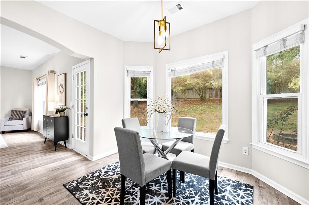 3720 Brookefall Landing Suwanee, GA 30024 - Photo 20 of 41 a view of a dining room with furniture window and wooden floor