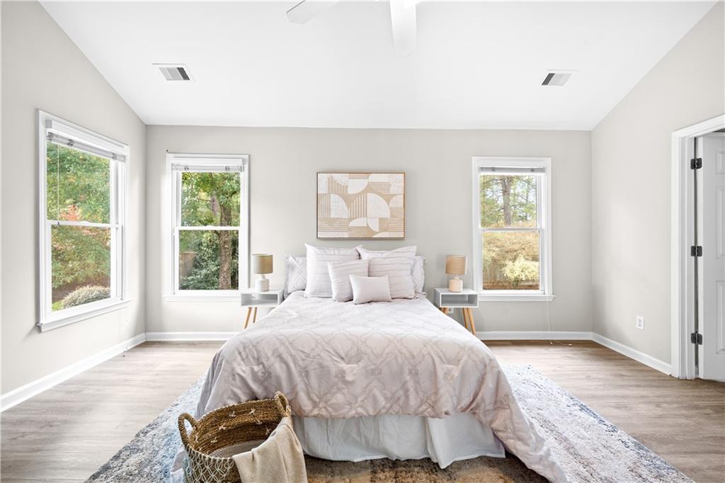 3720 Brookefall Landing Suwanee, GA 30024 - Photo 23 of 41 a bedroom with a bed and a large window