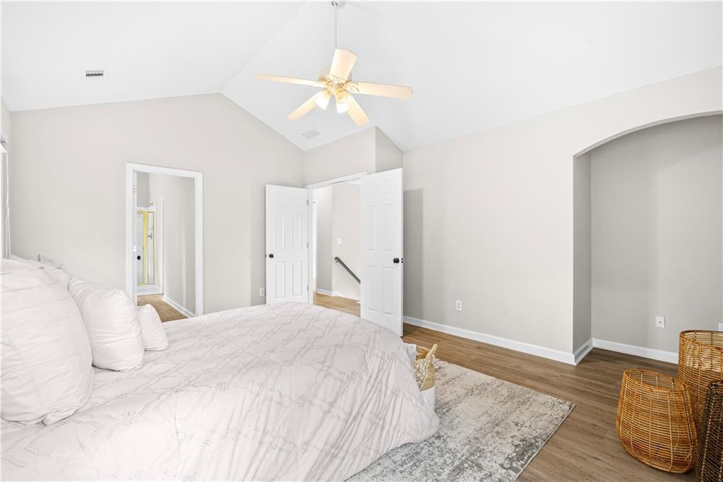 3720 Brookefall Landing Suwanee, GA 30024 - Photo 25 of 41 a bedroom with a bed and a chandelier