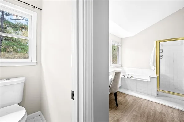 a bathroom with a tub sink and a mirror