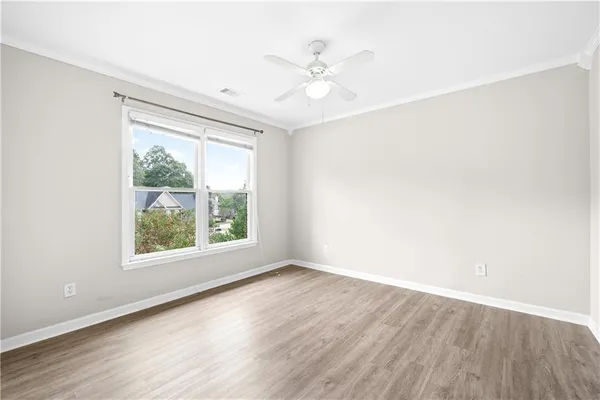 a view of an empty room with wooden floor