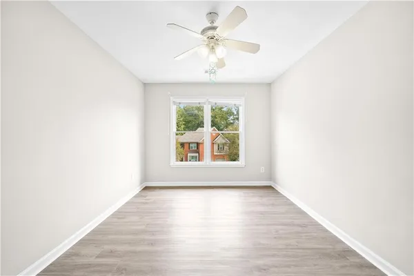 a view of an empty room with wooden floor