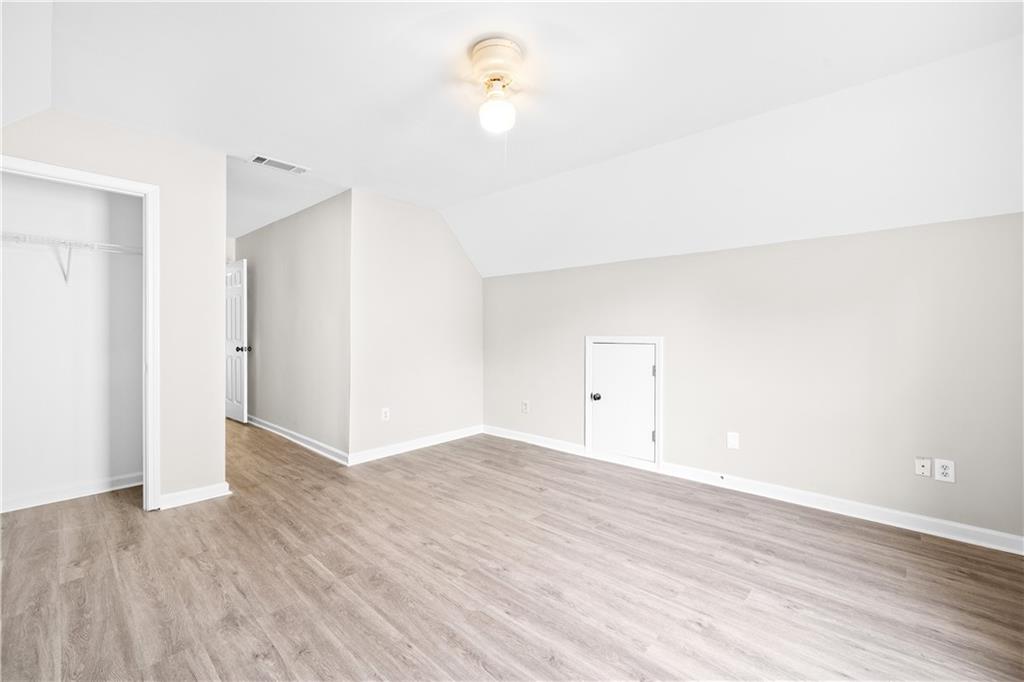 3720 Brookefall Landing Suwanee, GA 30024 - Photo 35 of 41 a view of a room with wooden floor and a ceiling fan