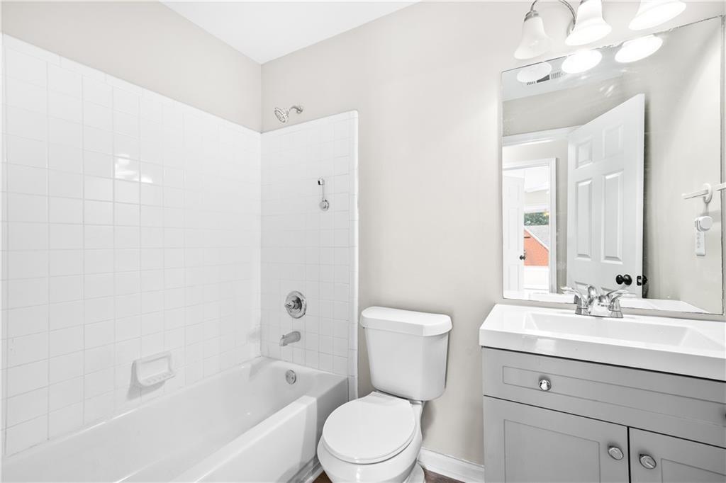 3720 Brookefall Landing Suwanee, GA 30024 - Photo 36 of 41 a bathroom with a sink a toilet and shower