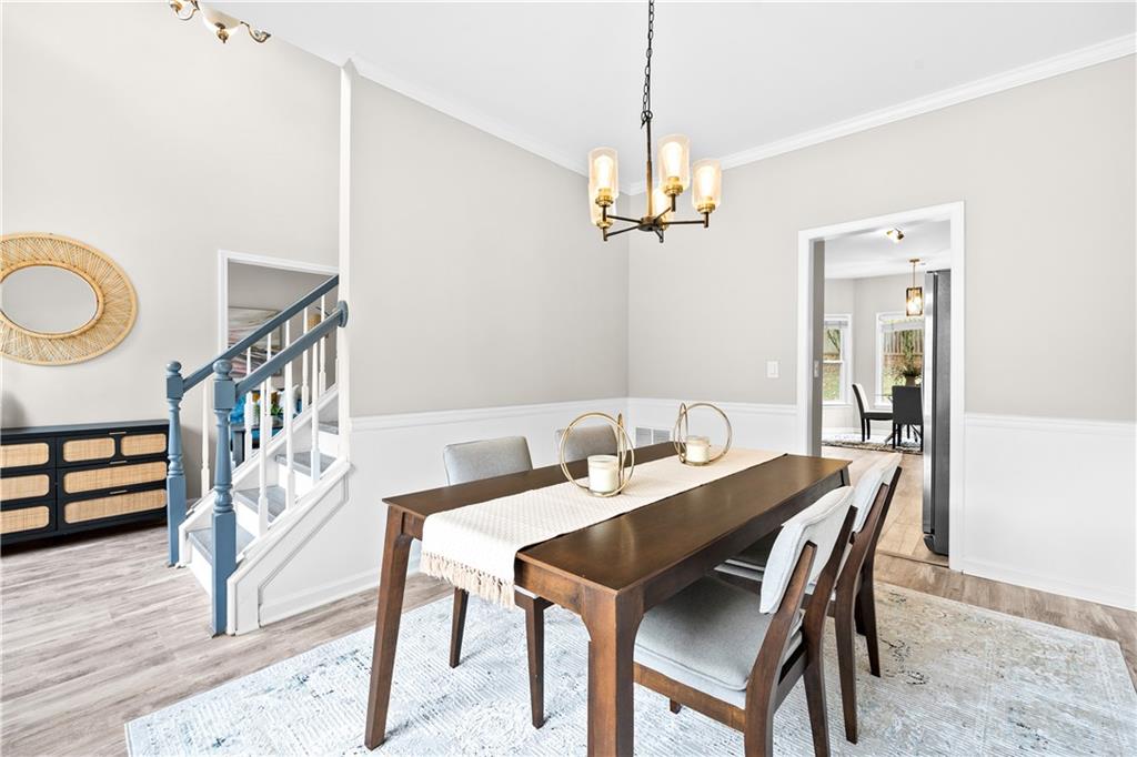3720 Brookefall Landing Suwanee, GA 30024 - Photo 10 of 41 a view of a dining room with furniture wooden floor and a chandelier