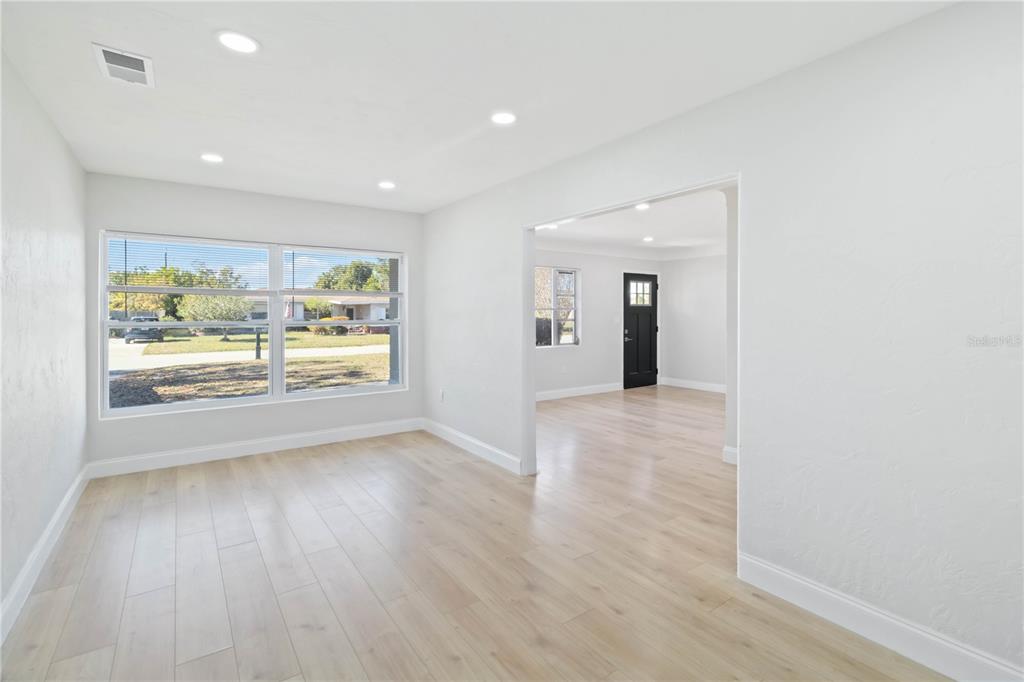 5337 60th Street North Kenneth City, FL 33709 - Photo 12 of 29 an empty room with wooden floor and windows