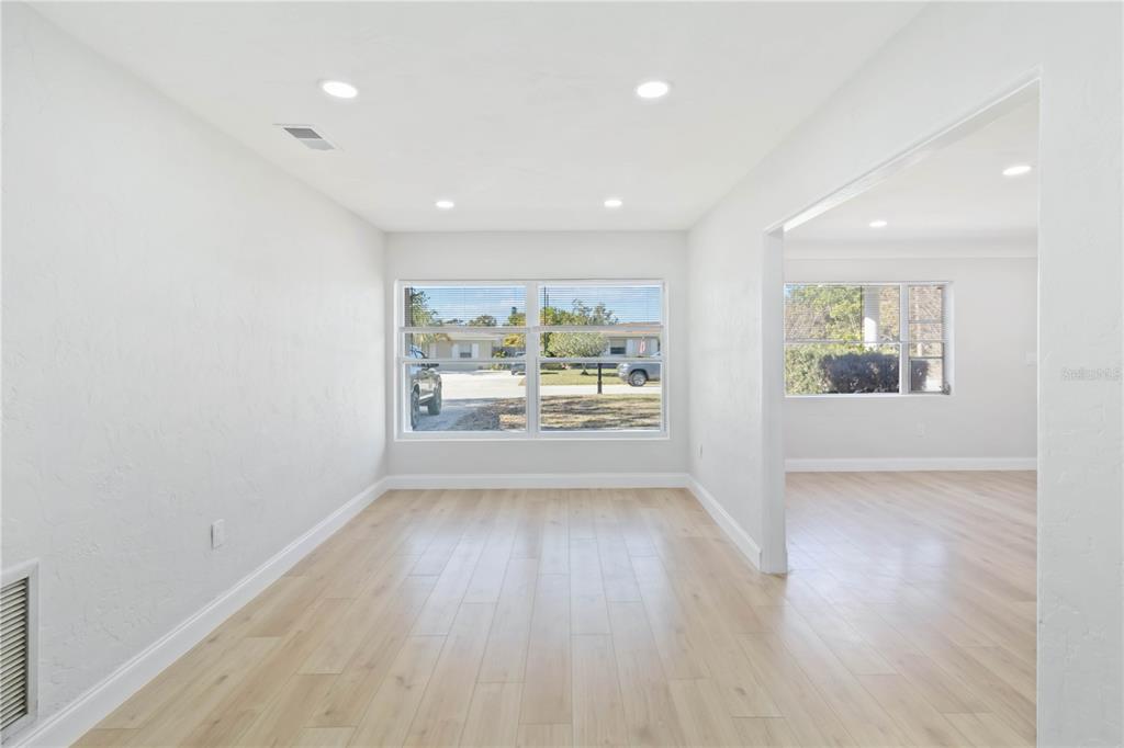 5337 60th Street North Kenneth City, FL 33709 - Photo 13 of 29 wooden floor in an empty room with a window