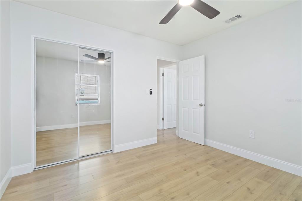 5337 60th Street North Kenneth City, FL 33709 - Photo 18 of 29 an empty room with closet and a chandelier fan