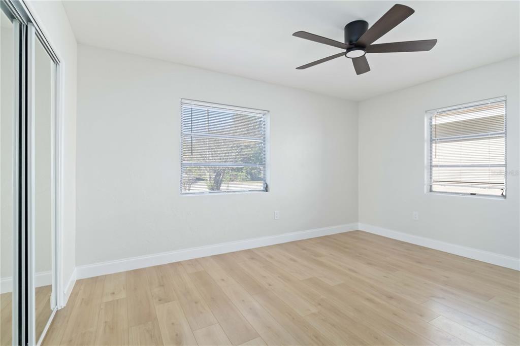 5337 60th Street North Kenneth City, FL 33709 - Photo 19 of 29 an empty room with a window and a ceiling fan
