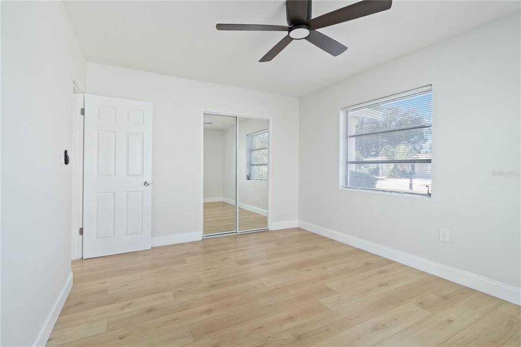 5337 60th Street North Kenneth City, FL 33709 - Photo 21 of 29 wooden floor in an empty room