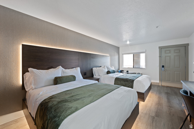 245 Red Cliffs Drive, Unit 104 St. George, UT 84790 - Photo 16 of 33 Bedroom with light wood-style floors and baseboards