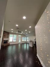 700 Auburndale Drive Euless, TX 76040 - Photo 4 of 7 a view of an empty room with wooden floor and a kitchen