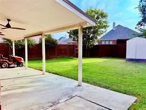 a view of a house with backyard and porch