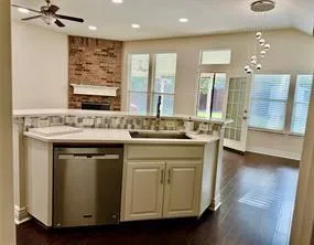 a kitchen with a sink stove and cabinets