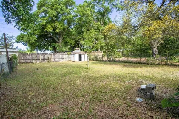 a view of yard with swimming pool and trees