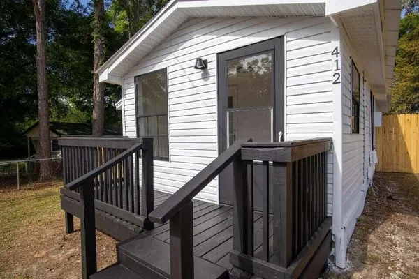 a view of balcony with wooden floor and fence