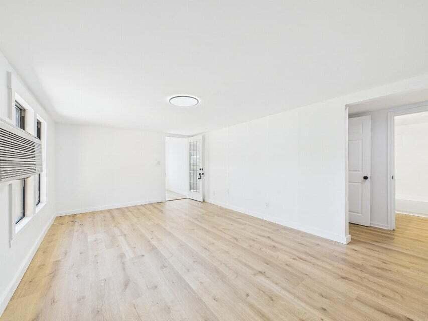 412 Church Street Crestview, FL 32539 - Photo 7 of 19 a view of empty room with wooden floor and fan