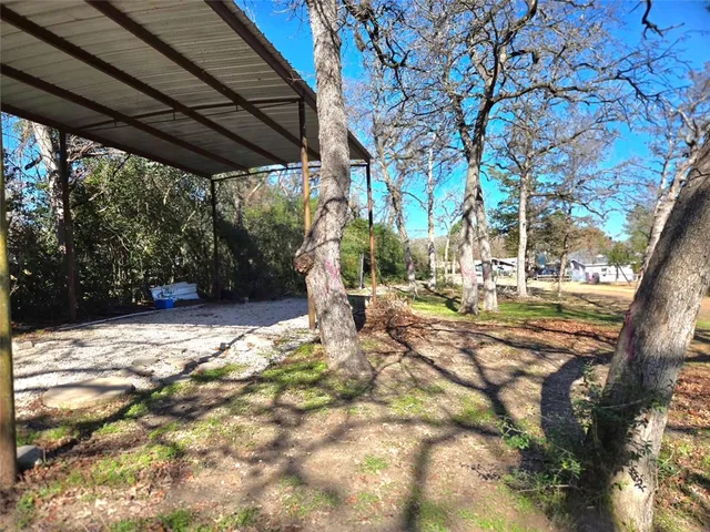 a view of yard with patio