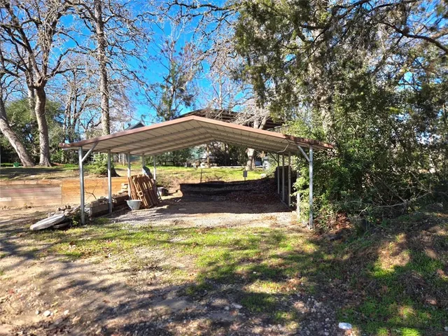 a view of a house with yard and sitting area
