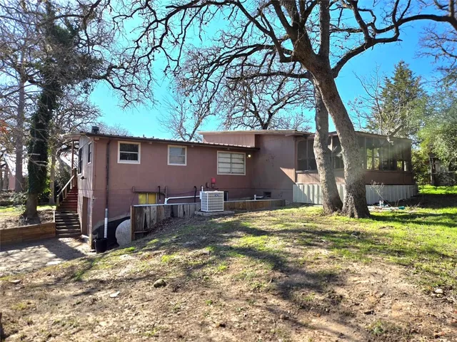 a backyard of a house with yard and outdoor seating
