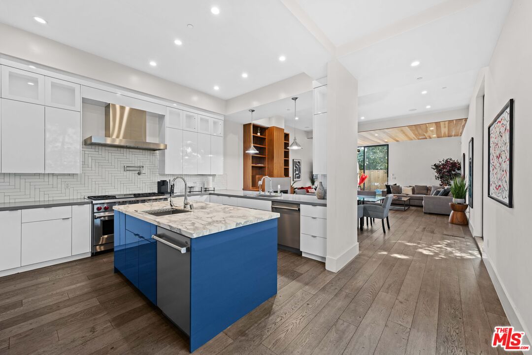 a kitchen with stainless steel appliances granite countertop wooden cabinets and sink