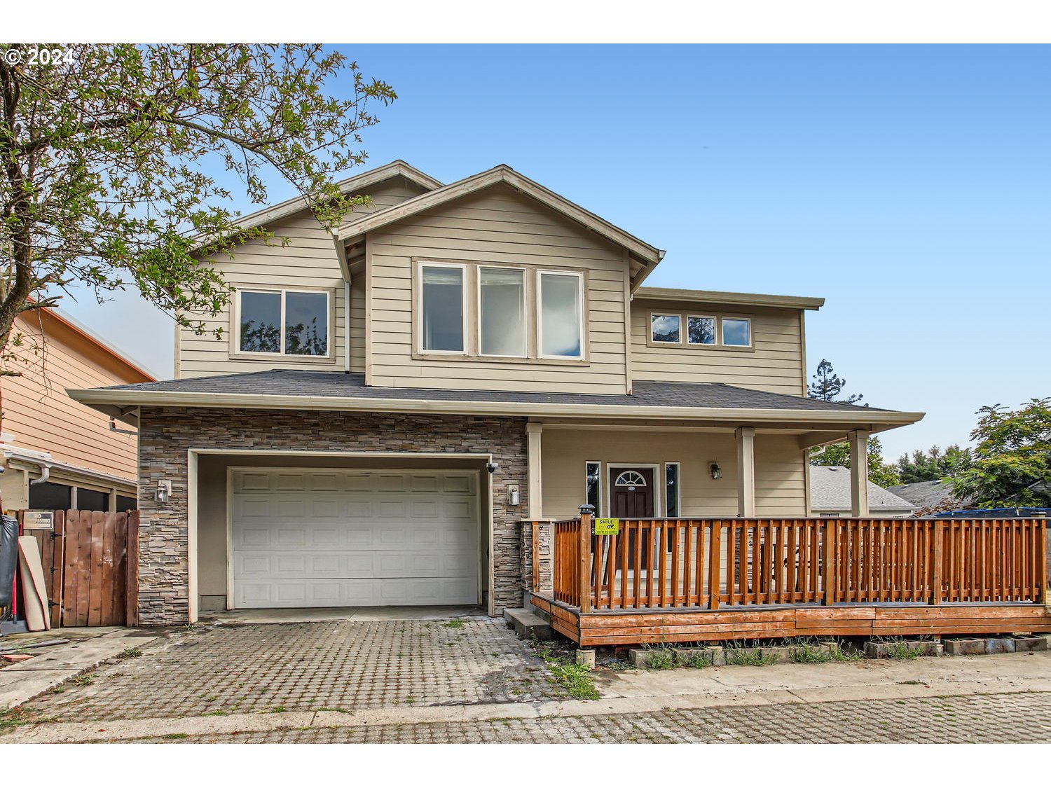 a view of a house with a wooden fence