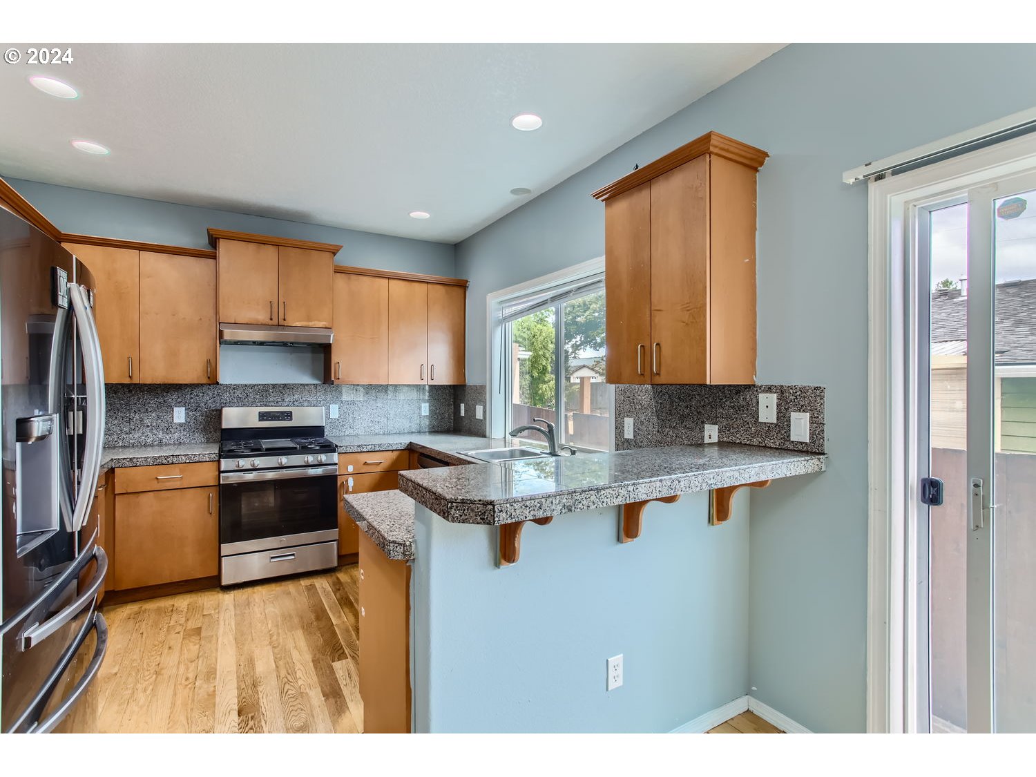 11405 Southeast Clinton Street Portland, OR 97266 - Photo 11 of 29 a kitchen with stainless steel appliances granite countertop a sink stove and refrigerator