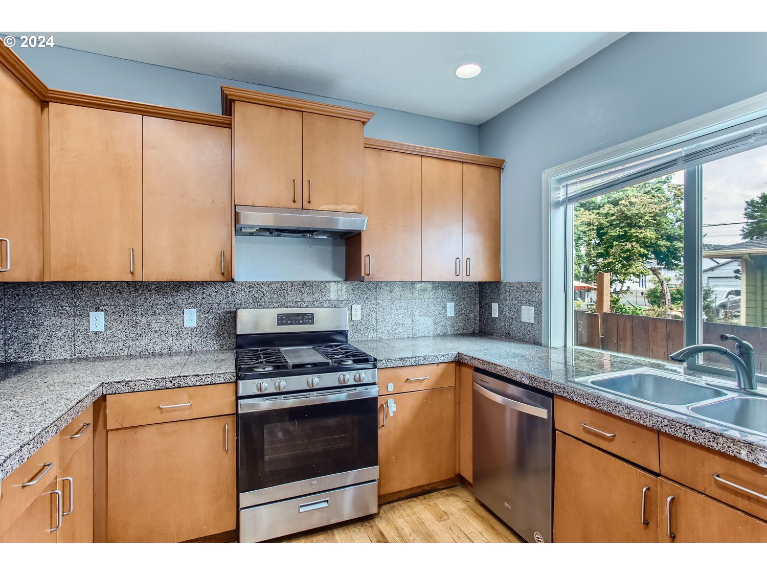11405 Southeast Clinton Street Portland, OR 97266 - Photo 12 of 29 a kitchen with granite countertop a sink stainless steel appliances and cabinets