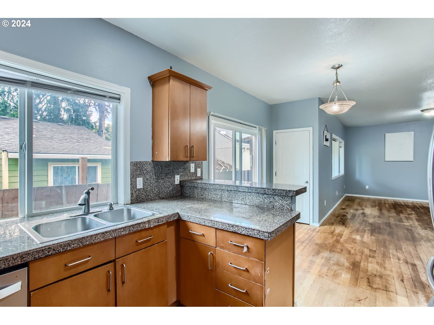 11405 Southeast Clinton Street Portland, OR 97266 - Photo 13 of 29 a kitchen with granite countertop a sink and cabinets