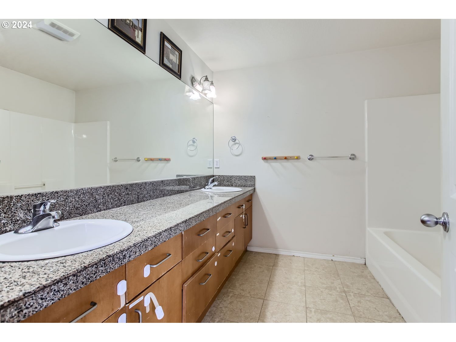 11405 Southeast Clinton Street Portland, OR 97266 - Photo 17 of 29 a bathroom with a granite countertop sink a mirror and a bathtub