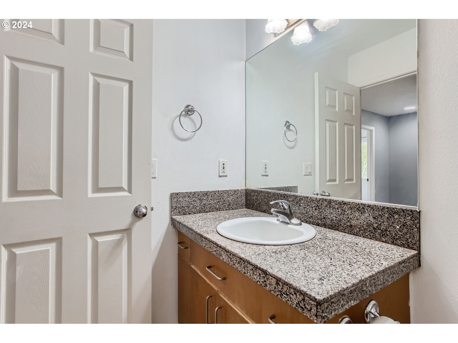 11405 Southeast Clinton Street Portland, OR 97266 - Photo 24 of 29 a bathroom with a granite countertop sink a mirror and a vanity