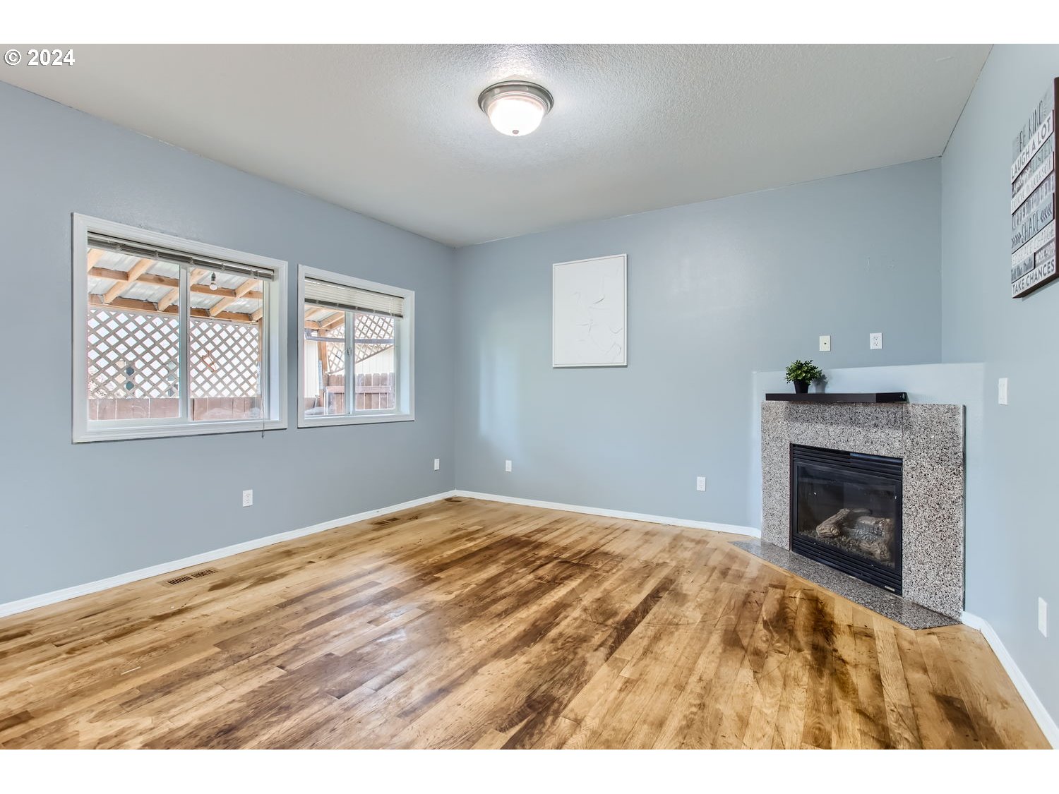 11405 Southeast Clinton Street Portland, OR 97266 - Photo 6 of 29 a bedroom with a bed and a fireplace