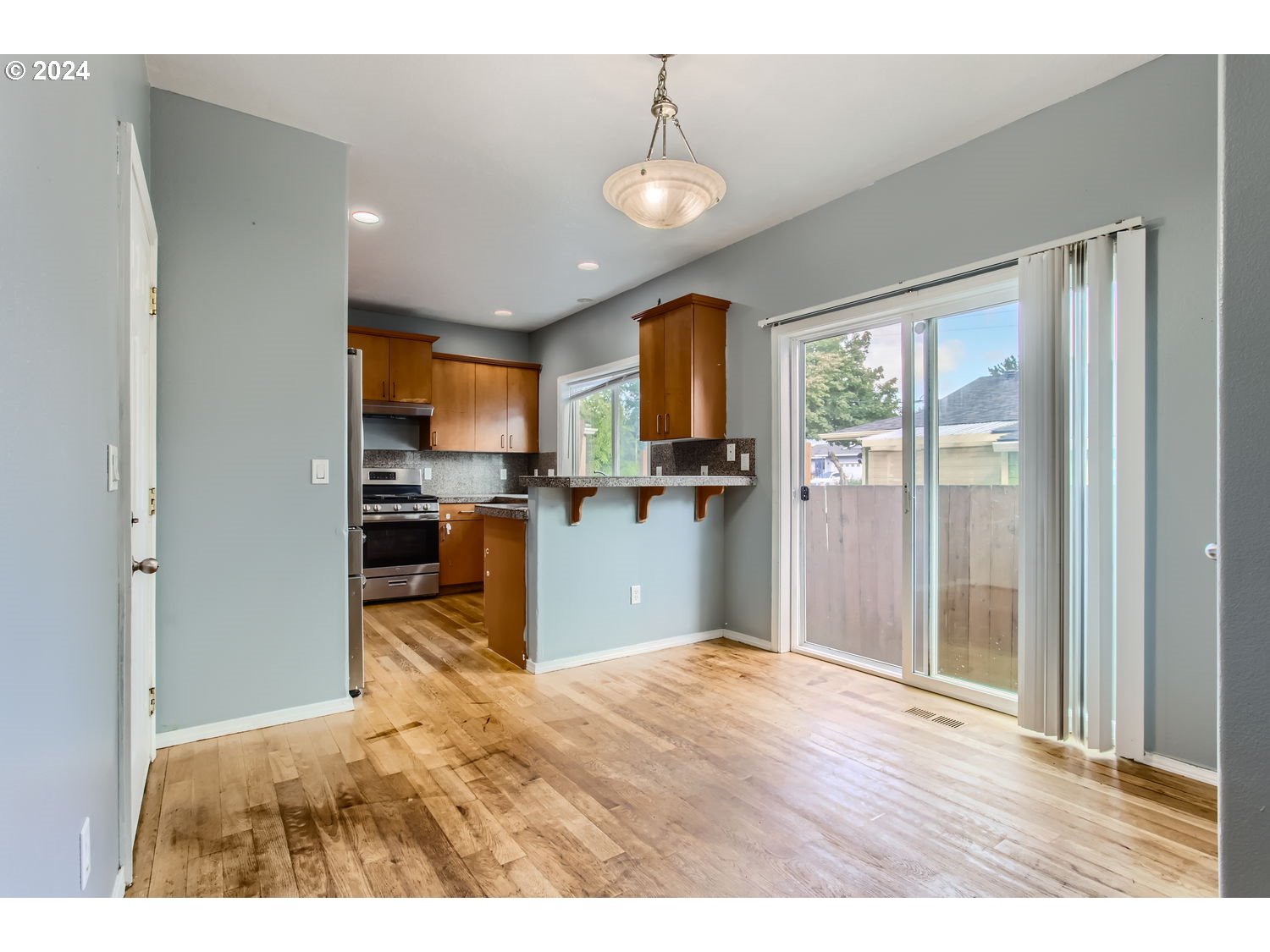 11405 Southeast Clinton Street Portland, OR 97266 - Photo 10 of 29 a room with stainless steel appliances granite countertop a refrigerator and a sink