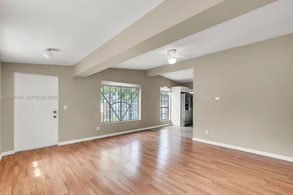 wooden floor in an empty room with a window
