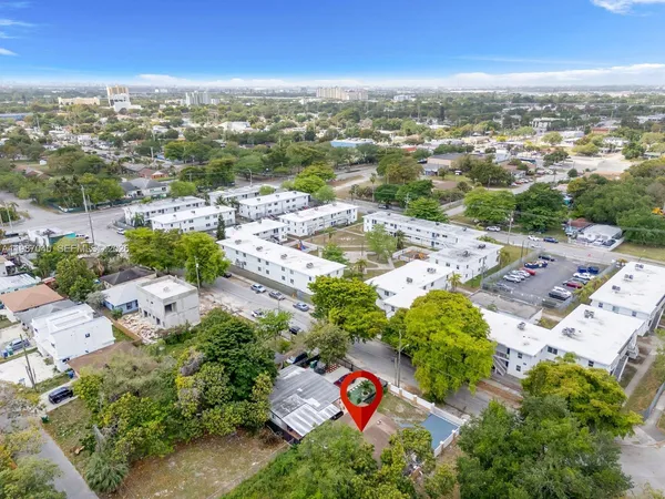 an aerial view of residential houses with outdoor space