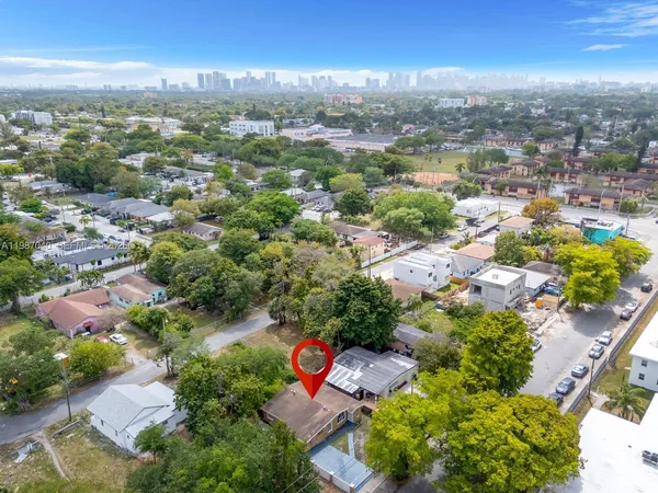 an aerial view of residential houses with outdoor space and river