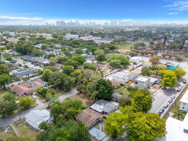 an aerial view of residential houses with outdoor space and ocean view