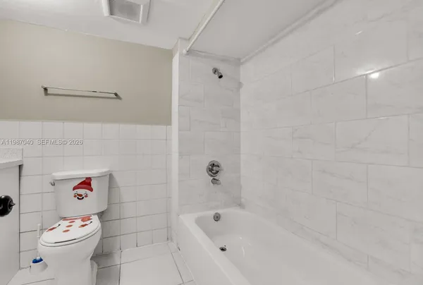 a bathroom with a bathtub and toilet