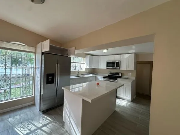 a kitchen with stainless steel appliances a refrigerator stove and microwave