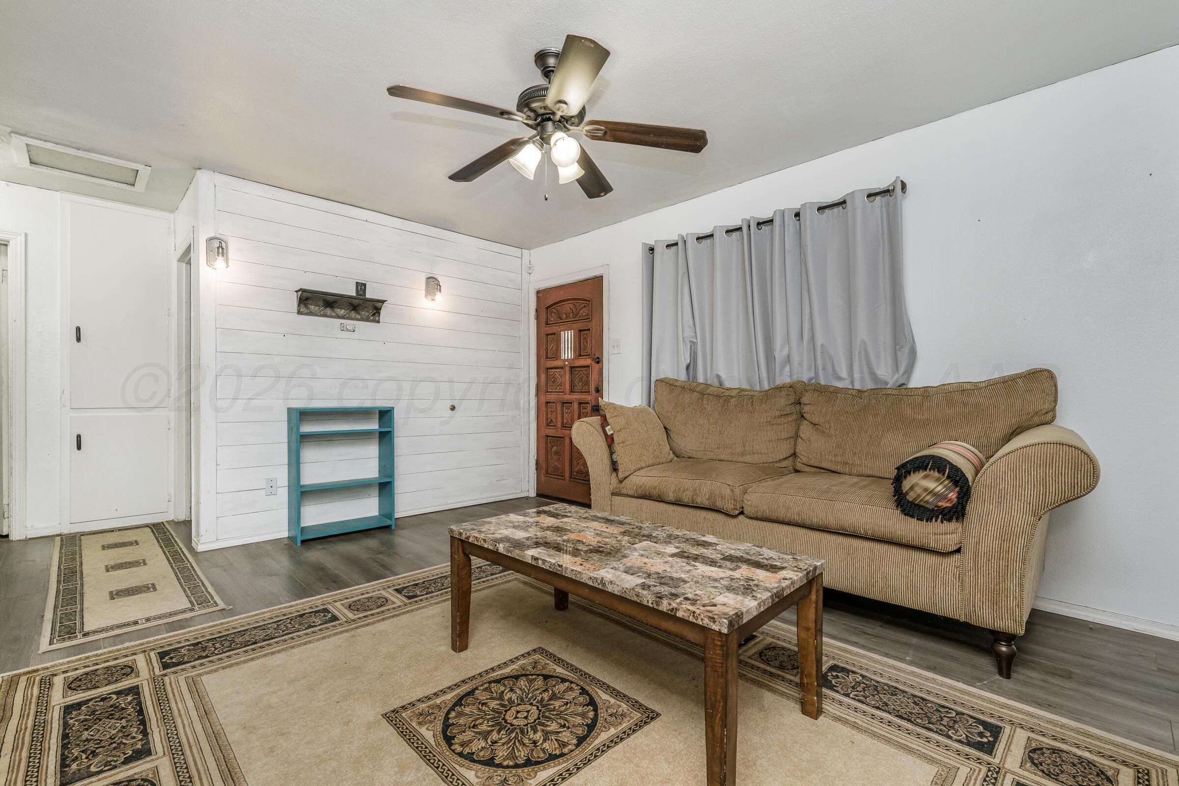 4429 Bowie Street Amarillo, TX 79110 - Photo 4 of 20 a living room with furniture and a fireplace