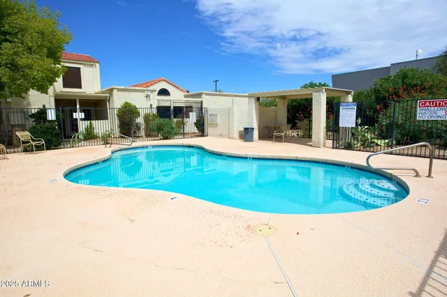 a view of a house with swimming pool and a yard