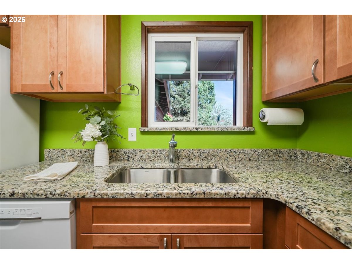 2035 Primrose Loop Philomath, OR 97370 - Photo 36 of 48 a kitchen with granite countertop a sink and a wooden cabinets