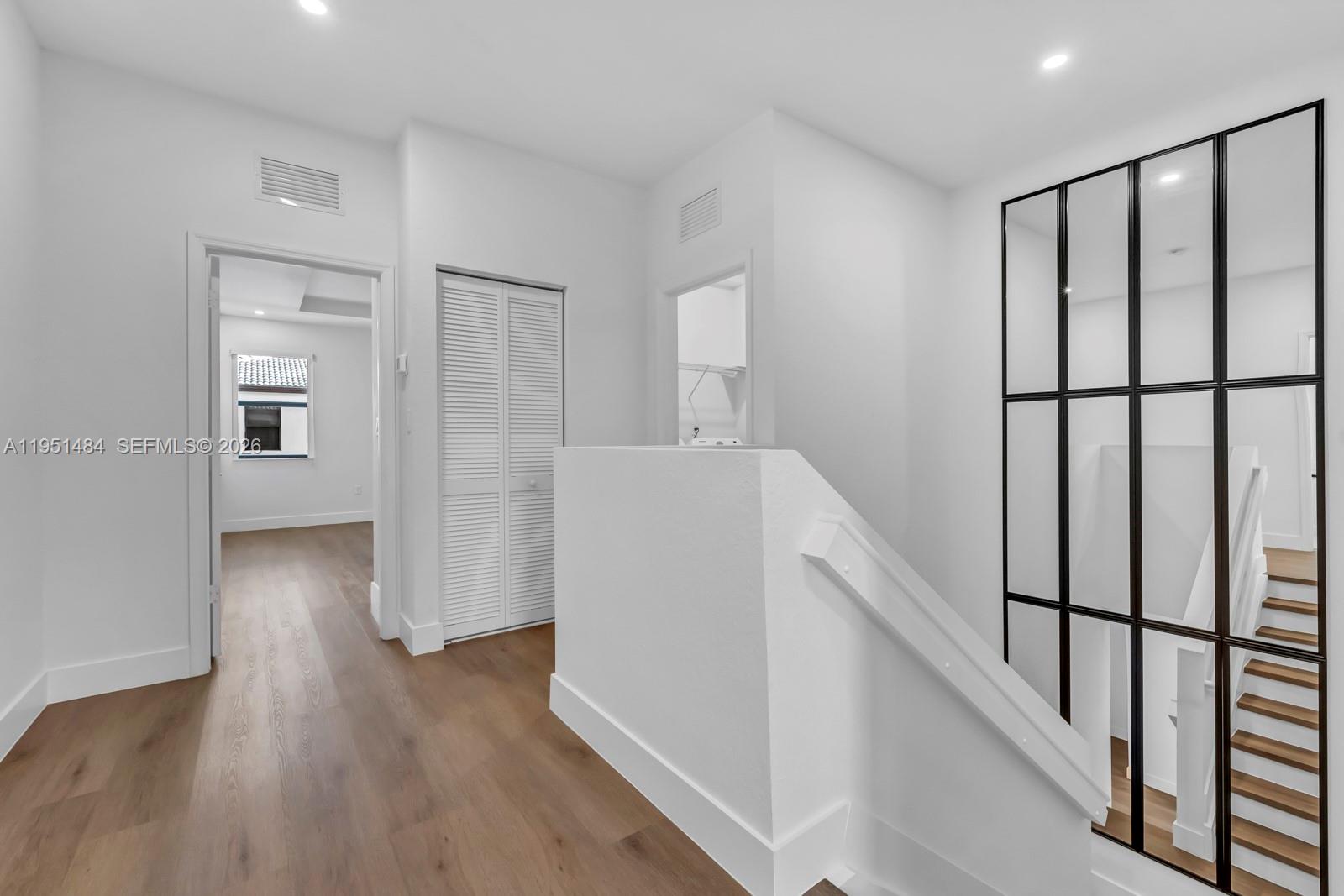 13067 Southwest 286th Street, Unit 13067 Homestead, FL 33033 - Photo 12 of 37 a view of a hallway with wooden floor and stairs