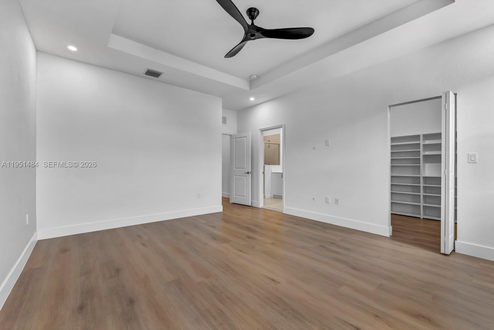13067 Southwest 286th Street, Unit 13067 Homestead, FL 33033 - Photo 13 of 37 wooden floor in an empty room with a window