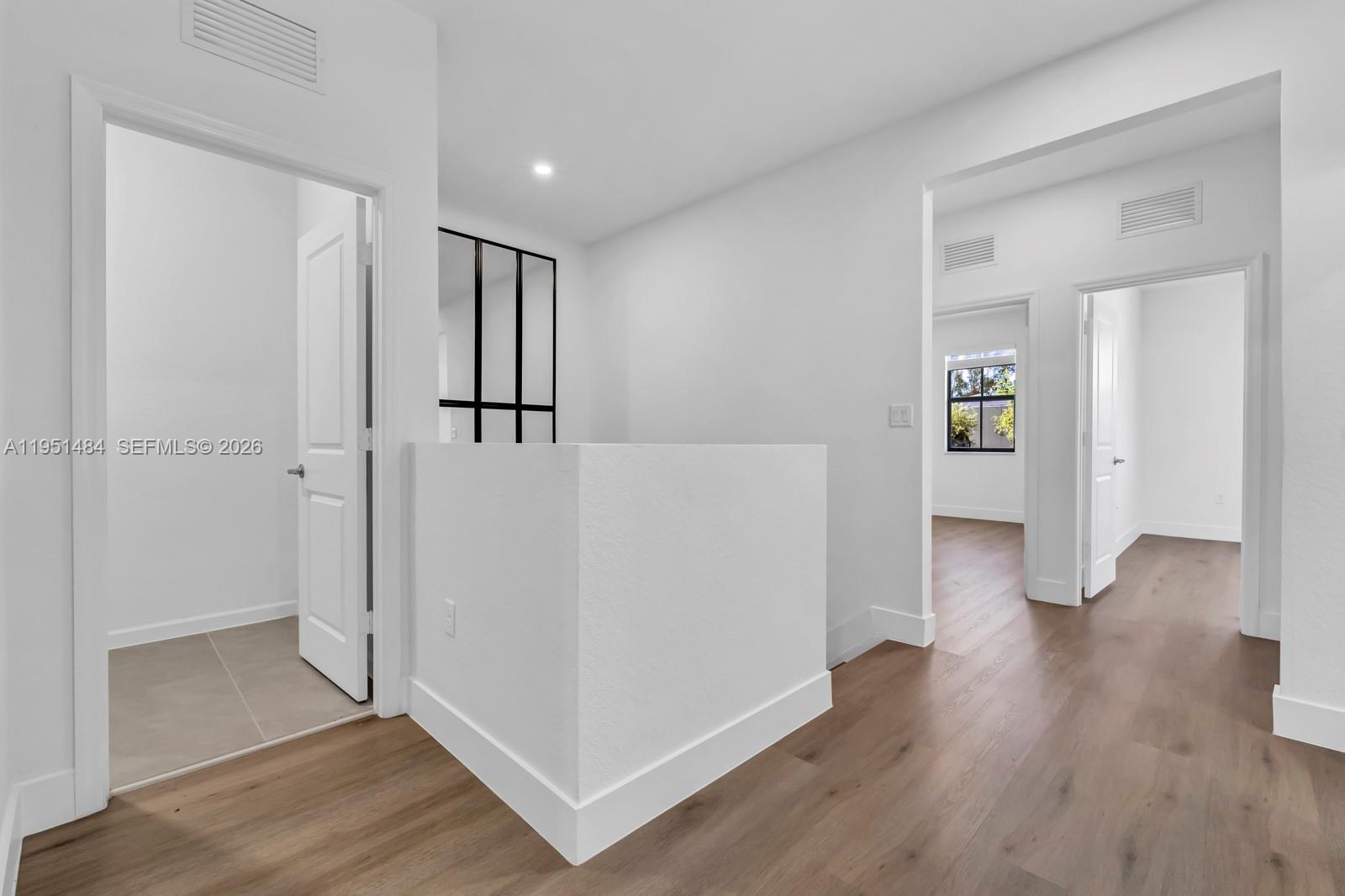 13067 Southwest 286th Street, Unit 13067 Homestead, FL 33033 - Photo 17 of 37 an empty room with wooden floor