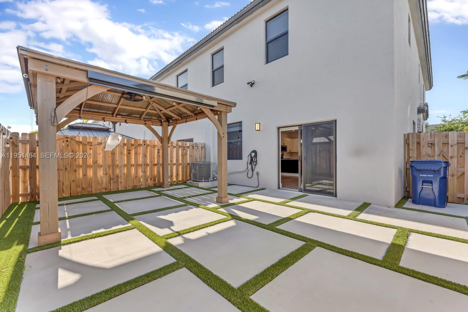 13067 Southwest 286th Street, Unit 13067 Homestead, FL 33033 - Photo 25 of 37 a patio with a table and chairs