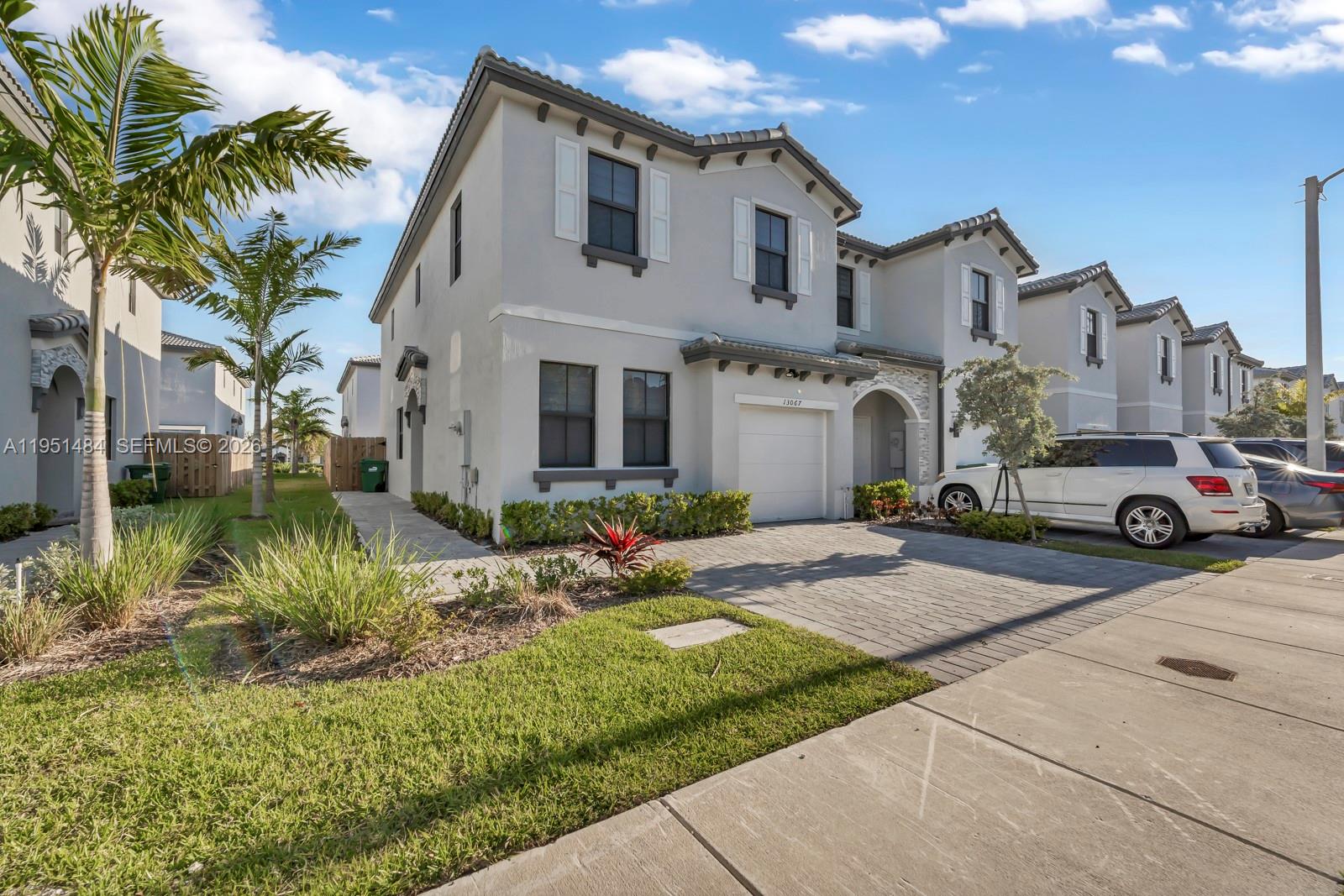 13067 Southwest 286th Street, Unit 13067 Homestead, FL 33033 - Photo 28 of 37 a house view with a garden space