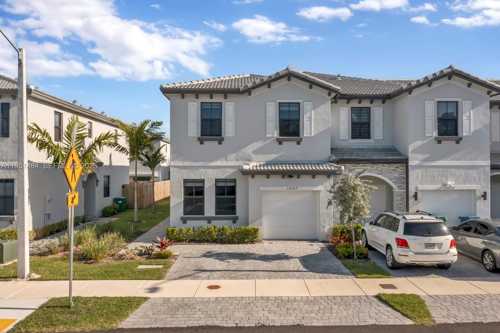 13067 Southwest 286th Street, Unit 13067 Homestead, FL 33033 - Photo 29 of 37 a view of a car park in front of house