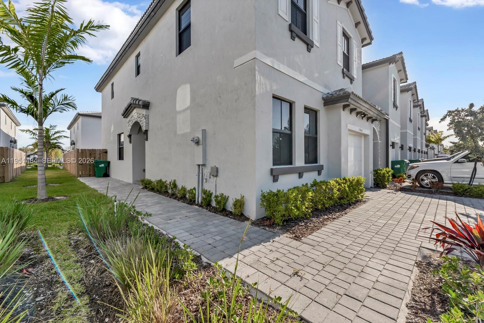 13067 Southwest 286th Street, Unit 13067 Homestead, FL 33033 - Photo 30 of 37 a front view of a house with garden